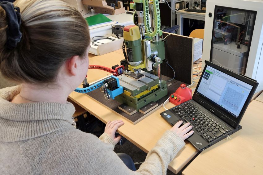 Studentin sitz am PC, daneben eine Maschine © HTW Berlin/Kai Schauer